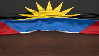 Antigua-and-Barbuda National Flag, Flag folded in half and placed on wood desk