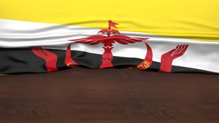 Brunei National Flag, Flag folded in half and placed on wood desk