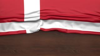 Denmark National Flag, Flag folded in half and placed on wood desk