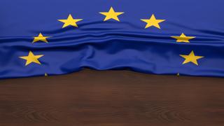 EU National Flag, Flag folded in half and placed on wood desk