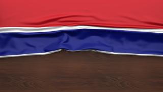 Gambia National Flag, Flag folded in half and placed on wood desk