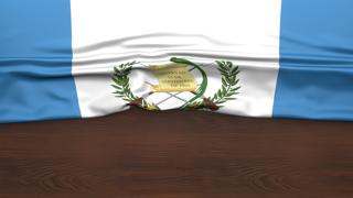 Guatemala National Flag, Flag folded in half and placed on wood desk