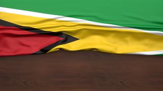 Guyana National Flag, Flag folded in half and placed on wood desk