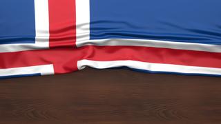 Iceland National Flag, Flag folded in half and placed on wood desk