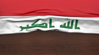 Iraq National Flag, Flag folded in half and placed on wood desk