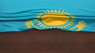 Kazakhstan National Flag, Flag folded in half and placed on wood desk