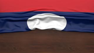 Laos National Flag, Flag folded in half and placed on wood desk