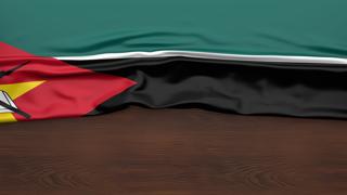 Mozambique National Flag, Flag folded in half and placed on wood desk