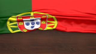 Portugal National Flag, Flag folded in half and placed on wood desk