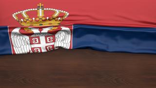 Serbia National Flag, Flag folded in half and placed on wood desk