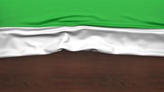 Sierra-Leone National Flag, Flag folded in half and placed on wood desk