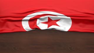 Tunisia National Flag, Flag folded in half and placed on wood desk