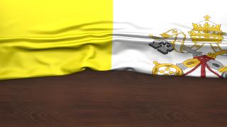 Vatican National Flag, Flag folded in half and placed on wood desk