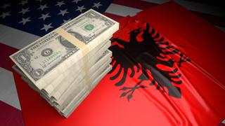 Albania National Flag, American dollars and flag placed on top of the American flag