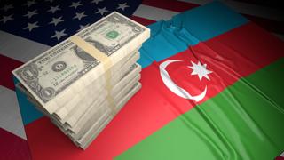 Azerbaijan National Flag, American dollars and flag placed on top of the American flag