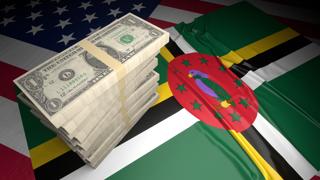 Commonwealth-of-Dominica National Flag, American dollars and flag placed on top of the American flag