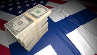 Finland National Flag, American dollars and flag placed on top of the American flag