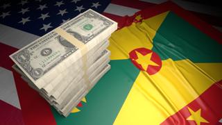 Grenada National Flag, American dollars and flag placed on top of the American flag