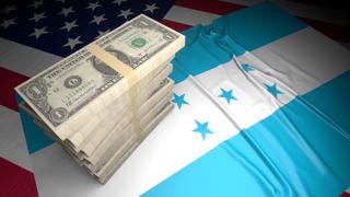 Honduras National Flag, American dollars and flag placed on top of the American flag