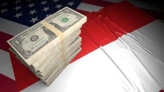 Indonesia National Flag, American dollars and flag placed on top of the American flag