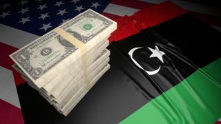 Libya National Flag, American dollars and flag placed on top of the American flag