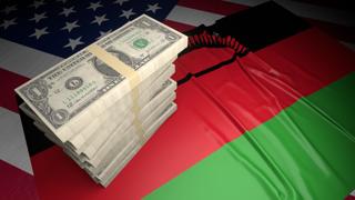 Malawi National Flag, American dollars and flag placed on top of the American flag