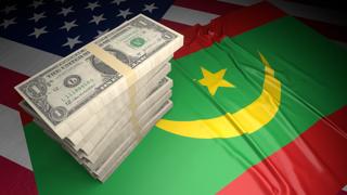 Mauritania National Flag, American dollars and flag placed on top of the American flag