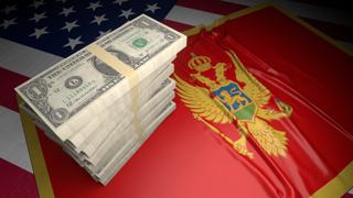 Montenegro National Flag, American dollars and flag placed on top of the American flag