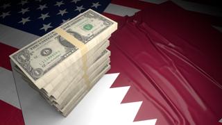 Qatar National Flag, American dollars and flag placed on top of the American flag