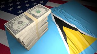 Saint-Lucia National Flag, American dollars and flag placed on top of the American flag