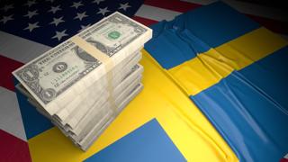 Sweden National Flag, American dollars and flag placed on top of the American flag