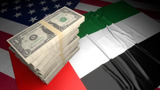 United-Arab-Emirates National Flag, American dollars and flag placed on top of the American flag