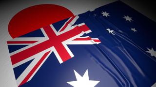 Australia National Flag, The national flag placed on top of the Japanese flag on a desk in a dark space