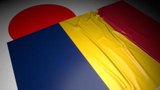 Chad National Flag, The national flag placed on top of the Japanese flag on a desk in a dark space