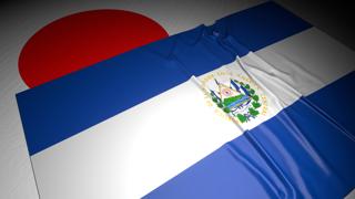 El-Salvador National Flag, The national flag placed on top of the Japanese flag on a desk in a dark space