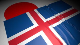 Iceland National Flag, The national flag placed on top of the Japanese flag on a desk in a dark space