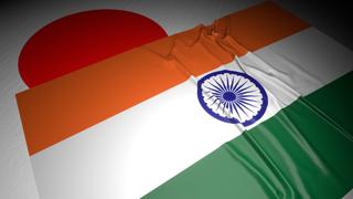 India National Flag, The national flag placed on top of the Japanese flag on a desk in a dark space