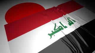 Iraq National Flag, The national flag placed on top of the Japanese flag on a desk in a dark space