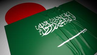 Saudi-Arabia National Flag, The national flag placed on top of the Japanese flag on a desk in a dark space