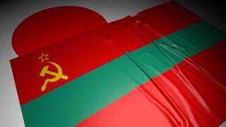 Transnistria National Flag, The national flag placed on top of the Japanese flag on a desk in a dark space