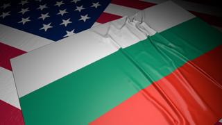 Bulgaria National Flag, A flag placed on top of an American flag on a desk in a dark space