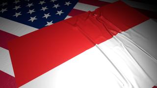 Indonesia National Flag, A flag placed on top of an American flag on a desk in a dark space