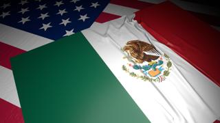 Mexico National Flag, A flag placed on top of an American flag on a desk in a dark space