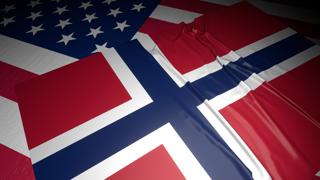 Norway National Flag, A flag placed on top of an American flag on a desk in a dark space