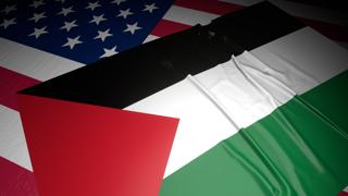 Palestine National Flag, A flag placed on top of an American flag on a desk in a dark space