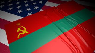 Transnistria National Flag, A flag placed on top of an American flag on a desk in a dark space