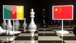 Cameroon National Flag, The national flag on a chessboard with the Japanese flag in the background