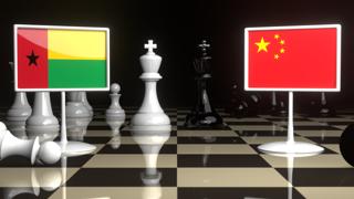 Guinea-Bissau National Flag, The national flag on a chessboard with the Japanese flag in the background