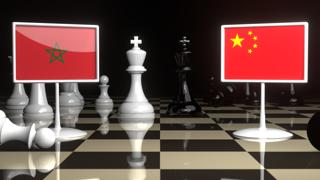 Morocco National Flag, The national flag on a chessboard with the Japanese flag in the background