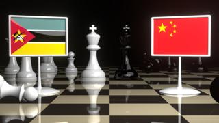 Mozambique National Flag, The national flag on a chessboard with the Japanese flag in the background